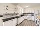 Modern kitchen with white cabinets, black hardware, updated countertops, and stainless appliances at 11310 W 46Th Ave, Wheat Ridge, CO 80033