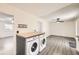 Convenient laundry area with front load washer and dryer near the kitchen and living room at 11310 W 46Th Ave, Wheat Ridge, CO 80033