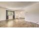 Bright living room with a large window, neutral walls, and modern flooring, offering a comfortable space at 11310 W 46Th Ave, Wheat Ridge, CO 80033