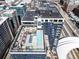 Stunning aerial view of the building with its rooftop pool, lounge, and cityscape backdrop at 1750 Wewatta St # 1230, Denver, CO 80202