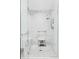 Elegant bathroom with a white tiled shower, glass door and tiled floor at 1750 Wewatta St # 1230, Denver, CO 80202