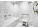 Elegant marble bathroom with a soaking tub and shower featuring modern fixtures and white tile at 1750 Wewatta St # 1230, Denver, CO 80202