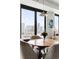 Bright dining area with city views, modern light fixture, and seating for four at 1750 Wewatta St # 1230, Denver, CO 80202