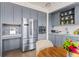 Well-appointed kitchen featuring stainless steel refrigerator, microwave, gray cabinets, and a cozy breakfast nook at 1750 Wewatta St # 1230, Denver, CO 80202