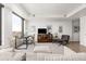 Bright living room features a large window, modern decor, hardwood floors and comfortable seating at 1750 Wewatta St # 1230, Denver, CO 80202