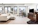 Bright living room with city views from expansive windows and modern furnishings at 1750 Wewatta St # 1230, Denver, CO 80202