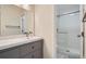 Bright bathroom featuring double sink vanity and glass enclosed shower at 9605 E Kansas Cir # 53, Denver, CO 80247