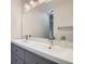 Modern bathroom featuring double sink vanity with chrome fixtures and large mirror at 9605 E Kansas Cir # 53, Denver, CO 80247