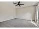 Spacious bedroom features gray carpet, exposed brick wall and bright natural light from sliding doors to outdoor balcony at 9605 E Kansas Cir # 53, Denver, CO 80247