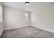 Bright bedroom featuring neutral gray carpet and small window at 9605 E Kansas Cir # 53, Denver, CO 80247