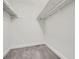 Walk-in closet provides ample storage space with wall to wall storage and neutral carpet at 9605 E Kansas Cir # 53, Denver, CO 80247