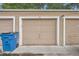 Individual garage featuring a well-maintained door, exterior light, and convenient access from the driveway at 9605 E Kansas Cir # 53, Denver, CO 80247