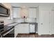 Well-appointed kitchen with stainless steel appliances, white cabinets, and ample counter space at 9605 E Kansas Cir # 53, Denver, CO 80247