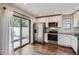 Updated kitchen boasts stainless steel appliances, sleek white cabinetry, and sliding glass door at 9605 E Kansas Cir # 53, Denver, CO 80247