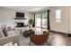 Bright living room features a white brick fireplace, hardwood floors, and sliding door access to outdoor space at 9605 E Kansas Cir # 53, Denver, CO 80247