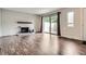 Comfortable living room with white brick fireplace, hardwood floors and access to outdoor space at 9605 E Kansas Cir # 53, Denver, CO 80247