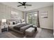 Bright main bedroom featuring exposed brick wall, ceiling fan and sliding glass doors to outdoor balcony at 9605 E Kansas Cir # 53, Denver, CO 80247