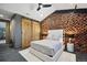 Chic bedroom with a stylish wood accent wall, sliding barn doors, and contemporary lighting at 6502 & 6200 Kiva Ridge Dr, Berthoud, CO 80513