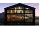 Modern home exterior with black trim and expansive windows reflected in the water at 6502 & 6200 Kiva Ridge Dr, Berthoud, CO 80513