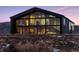 Stunning modern home with floor-to-ceiling windows showcasing the architectural design and expansive views at 6502 & 6200 Kiva Ridge Dr, Berthoud, CO 80513