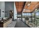 Hallway on second floor with wood ceilings and incredible views from the large picture windows at 6502 & 6200 Kiva Ridge Dr, Berthoud, CO 80513