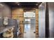 Stylish laundry room with stainless appliances, gray tile and rustic wood accents at 6502 & 6200 Kiva Ridge Dr, Berthoud, CO 80513