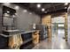 Modern laundry room with dark tile, unique wood supports, and stainless steel appliances at 6502 & 6200 Kiva Ridge Dr, Berthoud, CO 80513