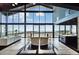 Bright living area with floor-to-ceiling windows, sleek furniture, and views of the expansive landscape at 6502 & 6200 Kiva Ridge Dr, Berthoud, CO 80513