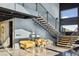 Bright living area featuring a unique staircase, polished concrete floors, and comfortable seating at 6502 & 6200 Kiva Ridge Dr, Berthoud, CO 80513