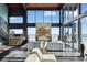 Bright living room with a fireplace, an open staircase, and expansive windows offering great views at 6502 & 6200 Kiva Ridge Dr, Berthoud, CO 80513