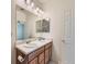 Bright bathroom featuring a double sink vanity and ample mirror space at 448 Bonanza Dr, Erie, CO 80516