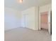 Spacious bedroom featuring a closet and doorway to another room at 448 Bonanza Dr, Erie, CO 80516