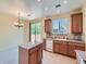 Functional kitchen with light wood cabinets, central island, and a dining area by sliding doors at 448 Bonanza Dr, Erie, CO 80516