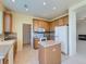 Cozy kitchen featuring wood cabinets, an island, and modern appliances at 448 Bonanza Dr, Erie, CO 80516