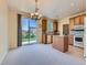Sunlit kitchen and dining area, featuring sliding glass doors to fenced yard at 448 Bonanza Dr, Erie, CO 80516
