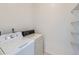 Functional laundry room with a washer, dryer, and built-in shelving for organization at 448 Bonanza Dr, Erie, CO 80516
