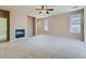 Inviting living room with a cozy fireplace and large windows offering plenty of natural light at 448 Bonanza Dr, Erie, CO 80516