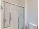 Tiled shower with glass sliding doors and modern fixtures, showcasing a clean design at 448 Bonanza Dr, Erie, CO 80516