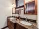 Bathroom with granite countertop, under sink storage and matching framed mirror cabinets at 1279 Estates Dr, Breckenridge, CO 80424