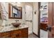 Bathroom vanity with copper vessel sink and granite countertop, adjacent to a tiled glass shower at 1279 Estates Dr, Breckenridge, CO 80424
