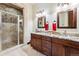 Bathroom featuring granite countertop vanity with dual sinks and a glass shower at 1279 Estates Dr, Breckenridge, CO 80424