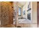 This luxurious bathroom includes a walk-in shower, soaking tub, and fireplace at 1279 Estates Dr, Breckenridge, CO 80424