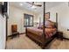 Comfortable bedroom featuring a four-poster bed, ceiling fan and large window at 1279 Estates Dr, Breckenridge, CO 80424
