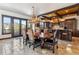 Open dining room featuring tile floors, antler chandelier, and mountain views through large windows at 1279 Estates Dr, Breckenridge, CO 80424