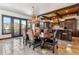 Bright dining room with mountain views, wood dining table, antler chandelier, and open to kitchen at 1279 Estates Dr, Breckenridge, CO 80424