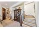 Inviting entryway with a wooden staircase, display cabinet, and neutral decor, creating a warm and welcoming ambiance at 1279 Estates Dr, Breckenridge, CO 80424