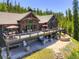 Gorgeous mountain home with an entertainment deck including a hot tub and gas firepit at 1279 Estates Dr, Breckenridge, CO 80424