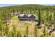 Breathtaking exterior view showing a large deck with a hot tub and outdoor gas fire pit at 1279 Estates Dr, Breckenridge, CO 80424