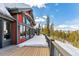 Exterior of home with multiple windows and snow covered deck overlooking mountain view at 1279 Estates Dr, Breckenridge, CO 80424