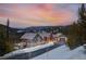 Beautiful exterior of mountain home features stone and siding, and stunning sunset views at 1279 Estates Dr, Breckenridge, CO 80424